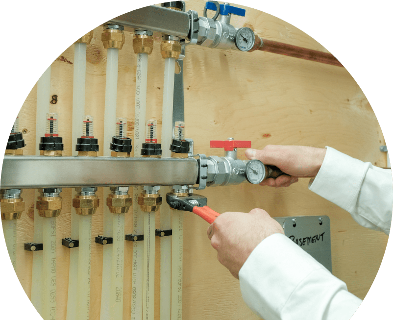 Wardlaw HVAC specialist performing boiler repair, adjusting internal components of a residential unit with visible copper piping and control wiring. Wardlaw HVAC specialist performing boiler repair, adjusting internal components of a residential unit with visible copper piping and control wiring.