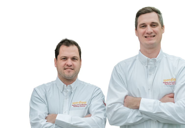 Two Wardlaw technicians smiling in front of their green service van, wearing issued jackets during an on-site consultation.